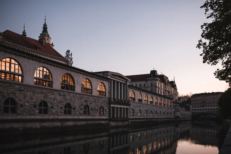 Ljubljana riverside arcades at golden hour